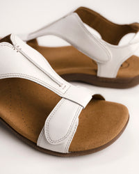 Women's Taos sandals. The Show comfort sandal features a premium white leather upper, adjustable straps, and a contoured cushioned footbed with arch support for all-day wear.