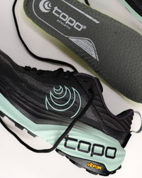 The Topo Vista is built for those who want to take on technical, rugged terrain without feeling the sting of the trail. As Topo’s premier max-cushion trail model, it features a high-stack 38mm x 33mm platform that provides a massive amount of underfoot protection. The rockered midsole design works in tandem with the plush ZipFoam™ compound to create a smooth, rolling transition that saves your legs during long-distance efforts and steep descents.