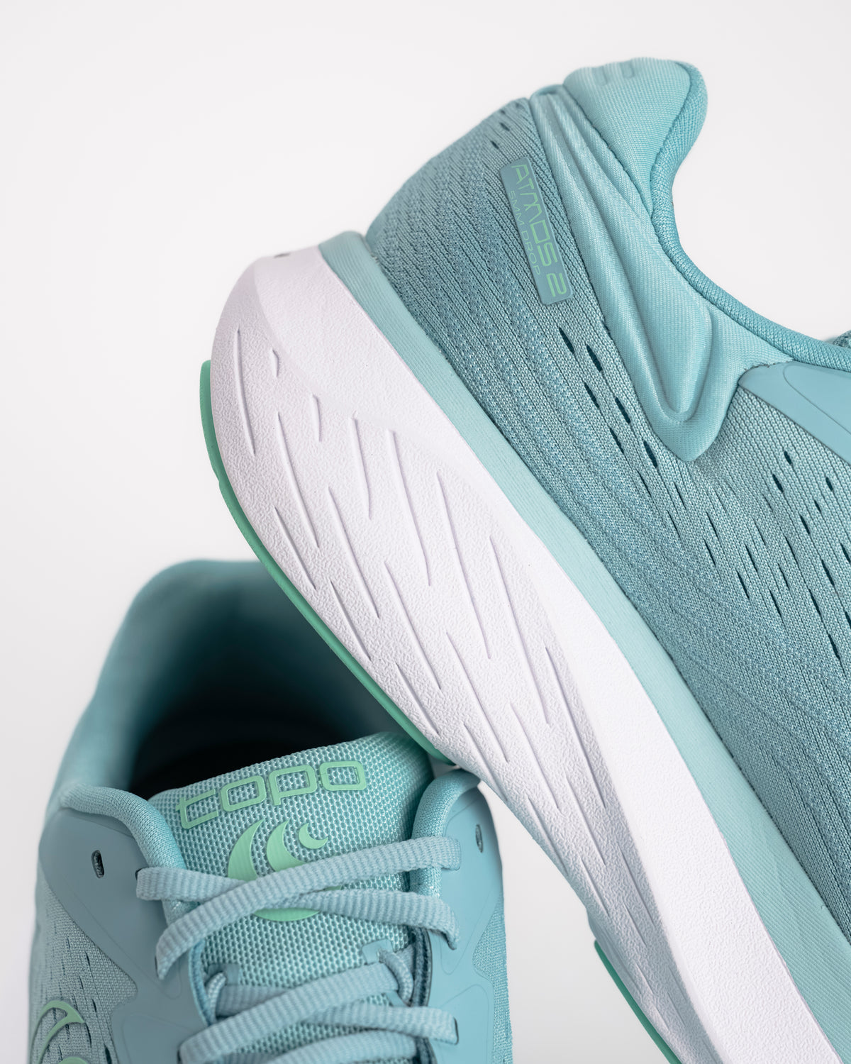 Midsole detail on the Women's Topo Atmos 2 in Aqua/Mint. It is the softest ride in the Topo lineup, built for those high-mileage days where comfort is the only thing that matters. This second-generation model features an even deeper bed of upgraded ZipFoam™, providing a plush, energetic feel that doesn't pack out over time. While many max-cushion shoes can feel clunky, the Atmos 2 uses a refined rocker geometry to keep your stride feeling smooth and fluid from heel-strike to toe-off.