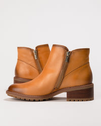 Side view focusing on the zip closure and streamlined silhouette of the boot.