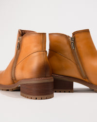 Rear view showing the heel height and seam details of the Medina ankle boot.