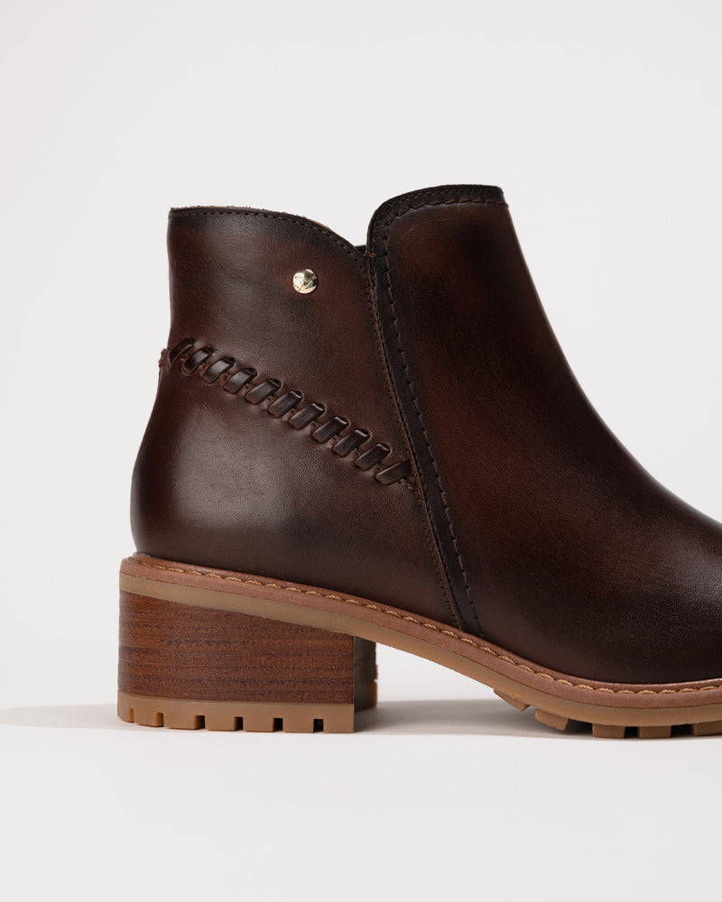 Close-up of the block heel and shaft contour detailing on the Medina boot.