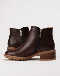Side view focusing on the zip closure and streamlined silhouette of the boot.