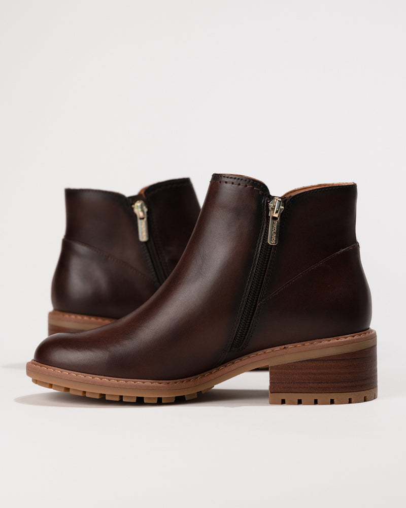 Side view focusing on the zip closure and streamlined silhouette of the boot.