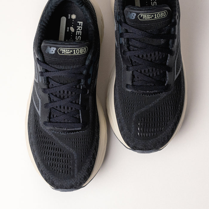 Overhead shot of the New Balance Fresh Foam X 1080 V14 in Black/Sea Salt, emphasizing the breathable jacquard mesh upper and lace-up design.