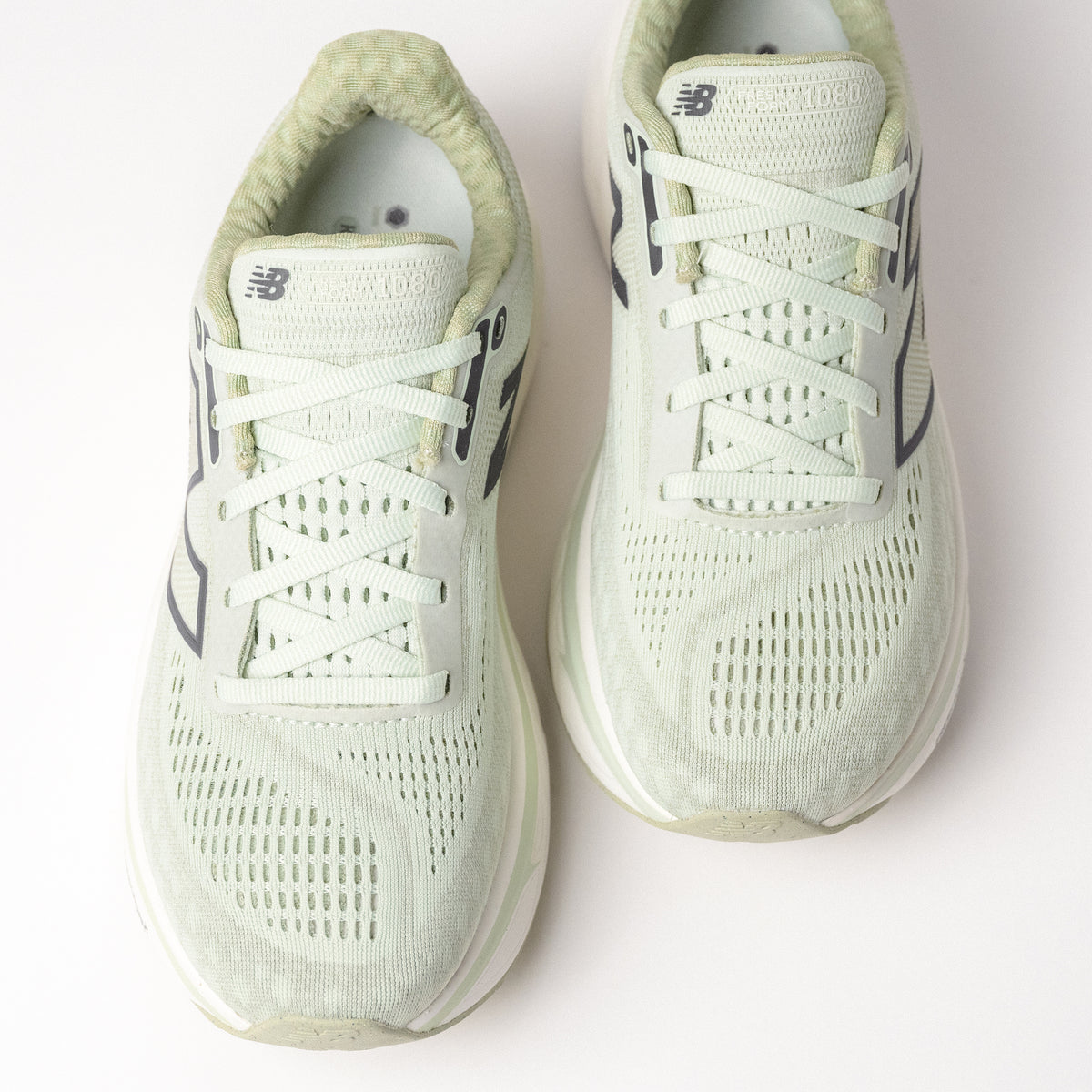 Overhead shot of the New Balance Fresh Foam X 1080 V14 in Natural Mint, emphasizing the breathable jacquard mesh upper and lace-up design.