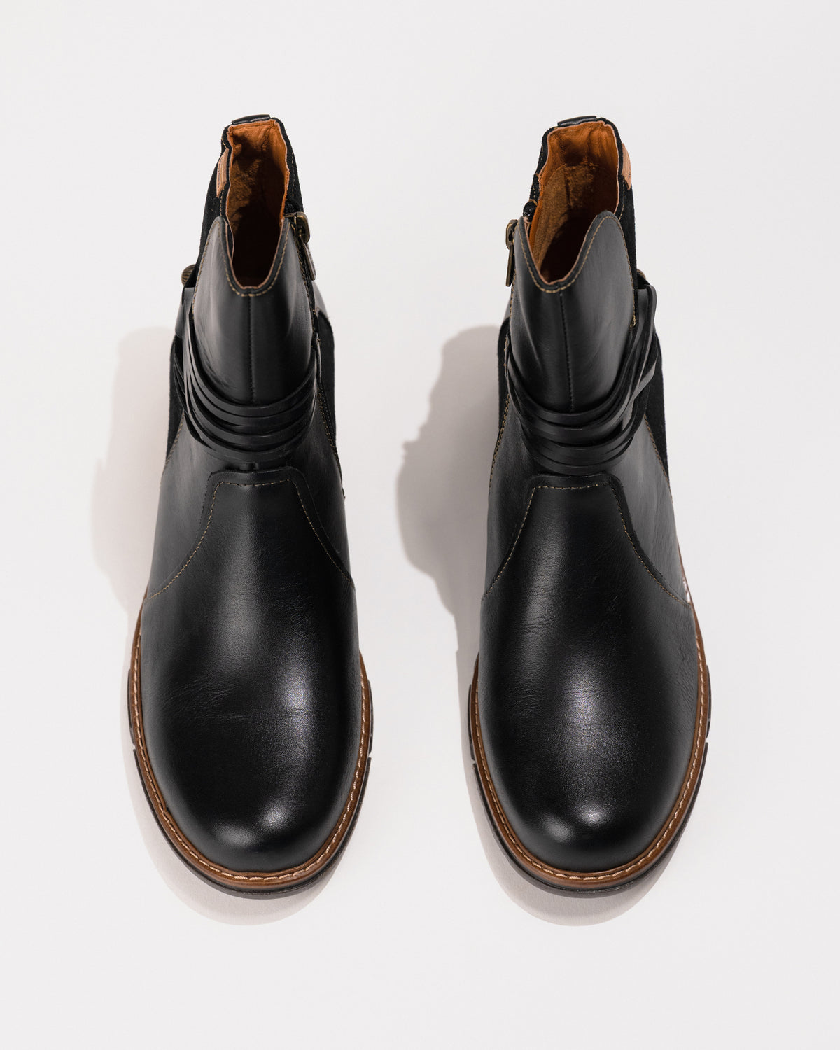 Top-down view highlighting the subtle round toe shape and curved shaft opening.