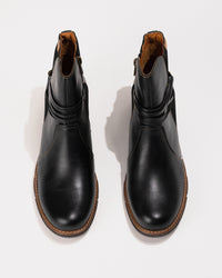 Top-down view highlighting the subtle round toe shape and curved shaft opening.