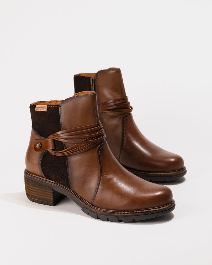 Angled view of the Pikolinos San Sebastian Boot in Topo/Brown leather showcasing the smooth leather, lace wrap, and zip entry.