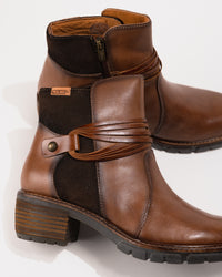 Close-up of the 2-inch heel, lace and rivet detail, and stitched shaft contour.