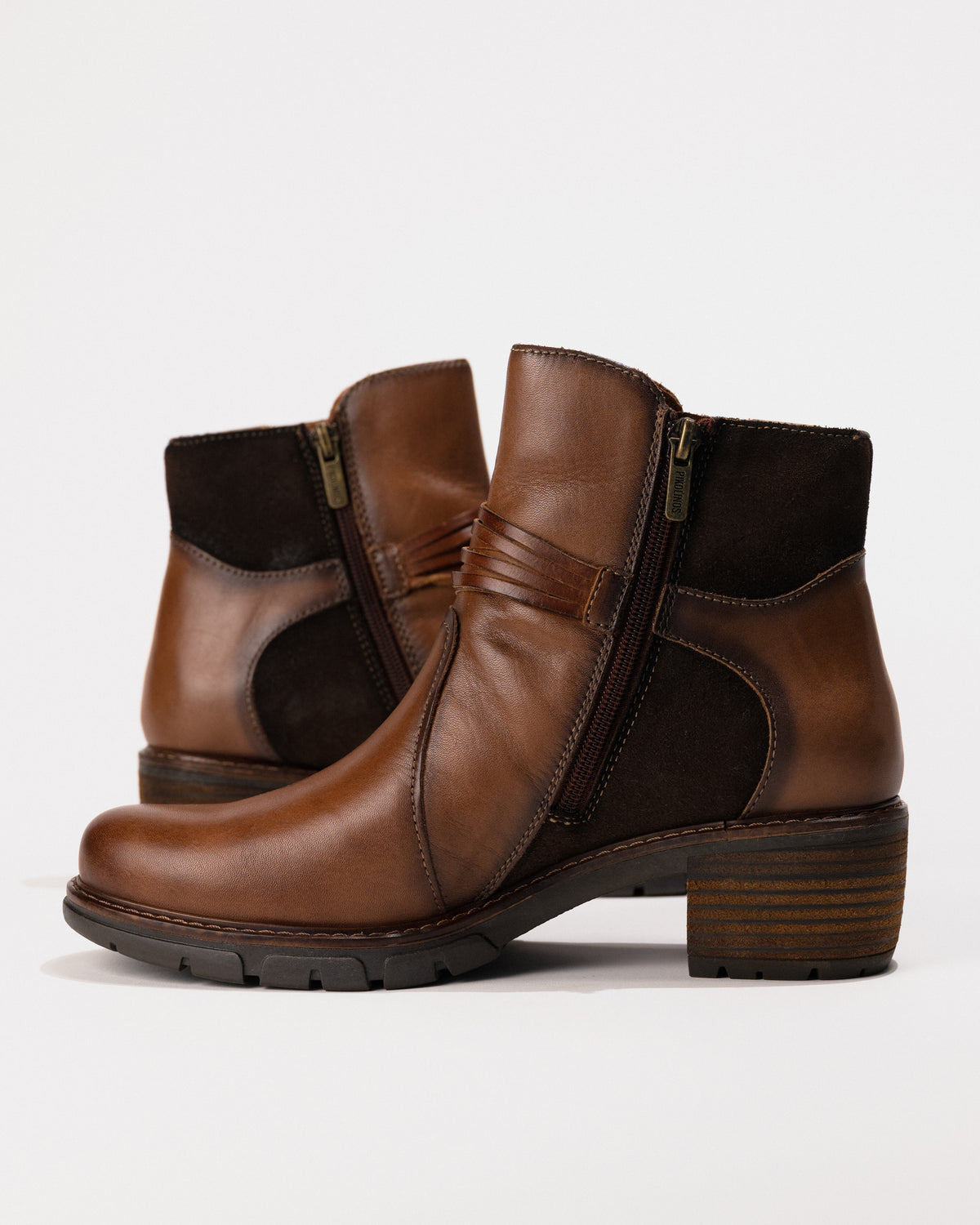 Side shot displaying the outer ankle, zipper easy-on design, and curved leather panels.
