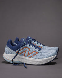 Pair of blue running shoes with orange accents on a gray background Women's New Balance Fresh Foam X 860 v14 Stability Shoe in Frost