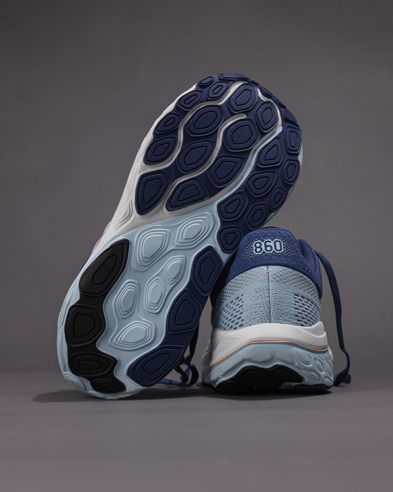 Pair of blue running shoes with a focus on sole texture and brand logo on a gray background Women's New Balance Fresh Foam X 860 v14 Stability Shoe in Frost