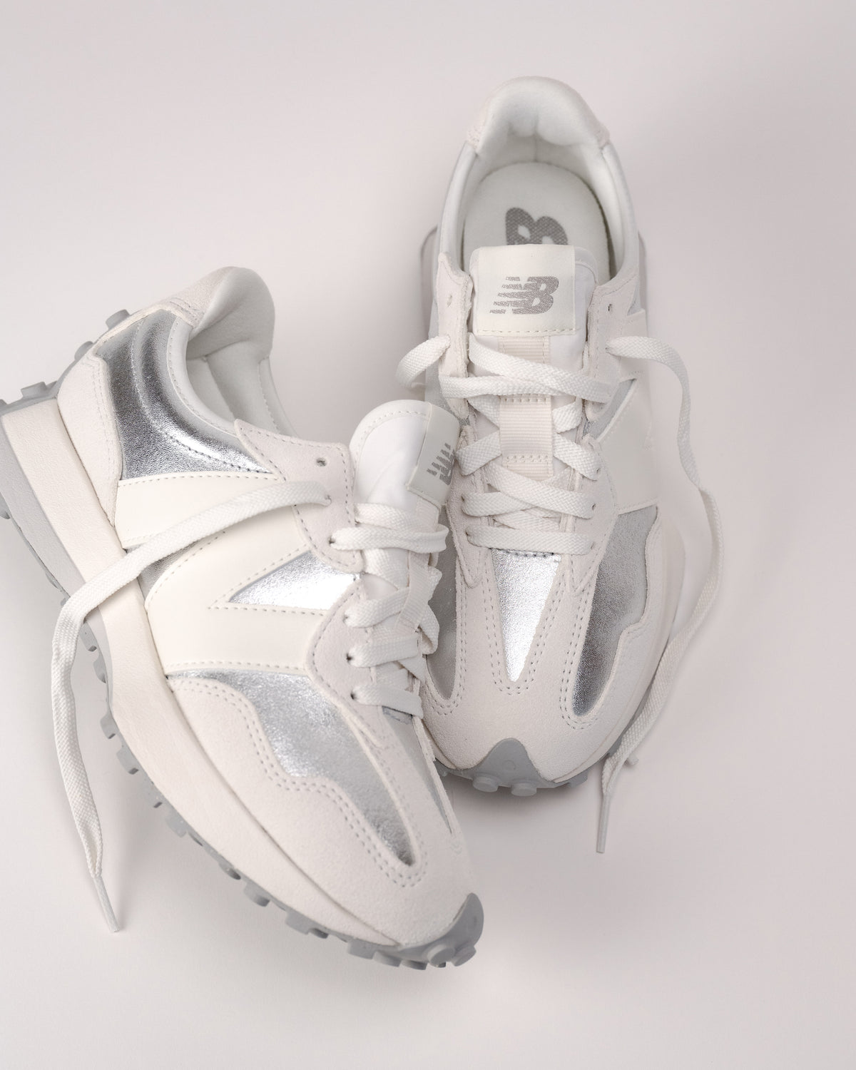 Top-down view of women’s New Balance 327 sneaker laces and nylon tongue