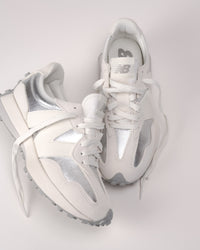 Top-down view of women’s New Balance 327 sneaker laces and nylon tongue