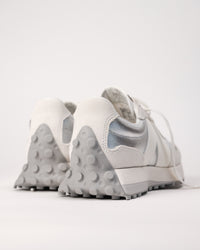 Back heel detail of New Balance 327 with textured rubber wrap and Silver metallic leather contrast